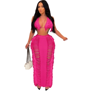 Detail of hot pink two-piece knit beach set with fringe tassels and high waist skirt
