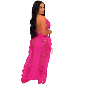 Detailed back view of fuchsia knit beach dress with halter neck and tassel accents