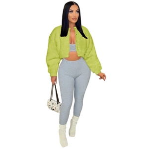 Detail of a bright green faux fur cropped jacket paired with a grey ribbed lounge set