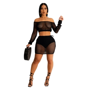 Detail of black knit hollow-out two-piece beach set with off-shoulder crop top and mini skirt