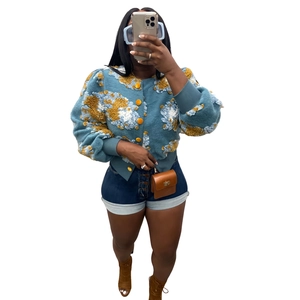 Blue textured short jacket with yellow floral accents and metal buttons close-up