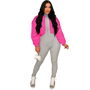 Close-up of rose pink faux fur jacket with grey ribbed knit jumpsuit on a fashion model