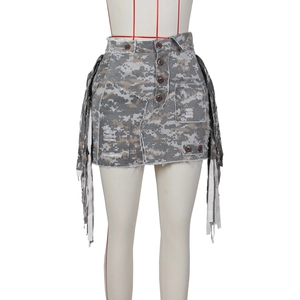 Detail view of camouflage mini skirt with utility pockets, fringed tassels and frayed hemline