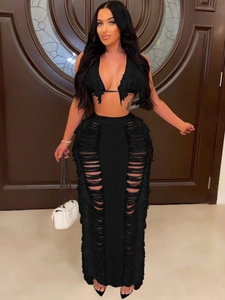 Women's sexy black two-piece knit beach set featuring halter top and fringe hollow-out skirt