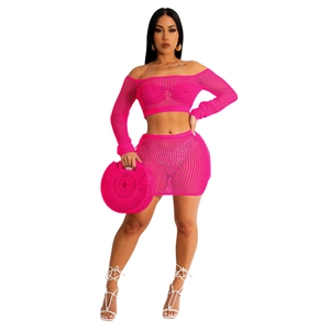 Hot pink crochet two-piece set featuring off-shoulder long sleeve top and mini skirt