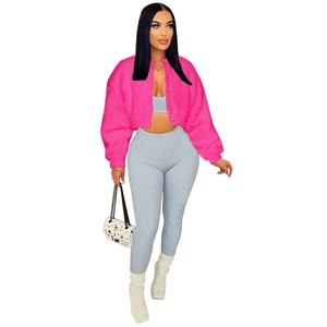 Detail of bright pink faux fur jacket paired with grey ribbed knit cropped top and pants