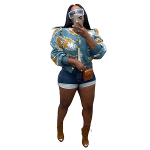 Close-up of vintage blue jacket featuring 3D floral texture and single-breasted buttons