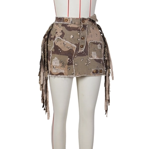 Detail of desert camouflage mini skirt featuring distressed patches and side tassels