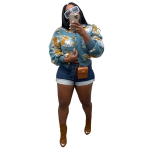 Detailed macro view of the 3D floral texture and yellow buttons on the blue knitted cardigan