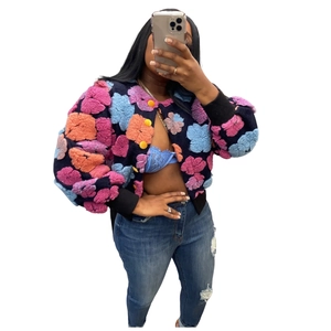 Close-up of vintage cardigan with colorful 3D flower jacquard and large yellow buttons