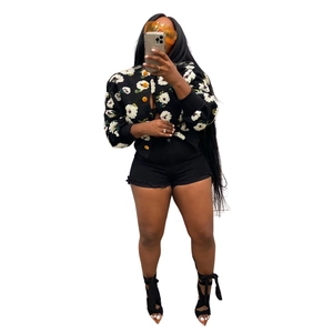 Detail of floral print jacket with yellow buttons and high-waisted denim shorts set