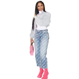 Detailed view of grey faux fur cropped jacket with blue branded straight-leg jeans and boots