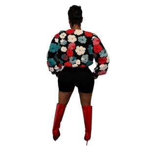 Rear view of vintage floral cardigan with 3D embossed jacquard and red patent boots