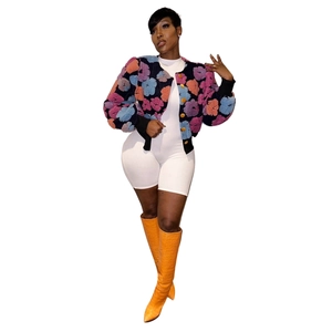 Detail of vibrant 3D floral texture jacket with gold buttons and colorful patchwork