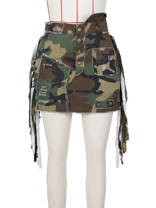 Camo mini skirt featuring distressed fringes and utilitarian pockets on a white mannequin