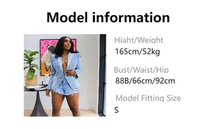 Detail view of denim blazer with golden buttons and frayed shorts on a fashion model