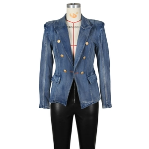 Detail of slim-fit double-breasted denim blazer with embossed gold lion buttons