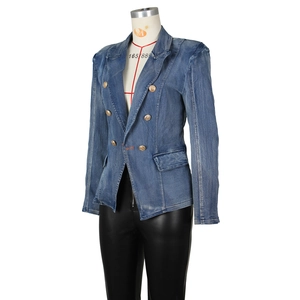 Detail of denim blazer with gold lion buttons and structured shoulder design