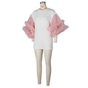Detail of white cotton T-shirt dress featuring pink pleated mesh puff sleeves and round neck