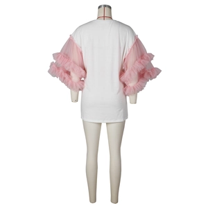 Detailed close-up of white t-shirt featuring layered pink mesh ruffle puff sleeves