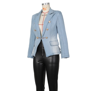 Detail of light blue denim blazer with gold lion buttons and faux leather pants