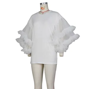 Detail of white cotton top featuring multi-layered sheer mesh ruffle sleeves and round neck