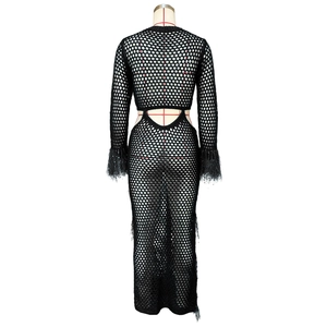 Close-up of black crochet knit maxi dress with fringe sleeves and hollow-out mesh texture