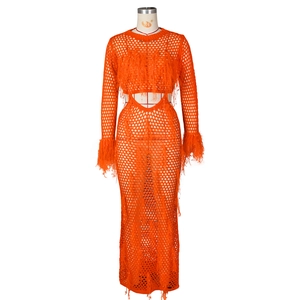 Detail of orange crochet mesh maxi dress with long sleeves and feather fringe accents