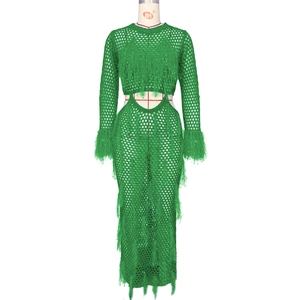 Detail of bright green crochet beach dress with hollow waist and long fringe accents