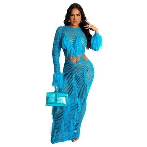 Close-up of bright blue hollow knit dress with matching feather trim and waist cut-out