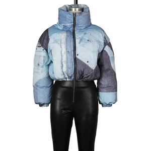 Detail of creative blue patchwork denim padded jacket with high stand collar and zipper