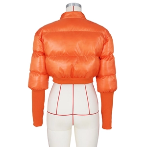 Rear view of bright orange shiny cropped puffer jacket featuring a high stand collar