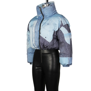 Detail of vintage patchwork denim puffer jacket with star patterns and stand collar