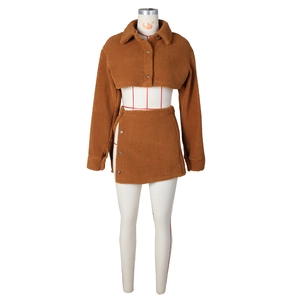 Detail of brown teddy fleece fabric and button accents on a two-piece skirt set