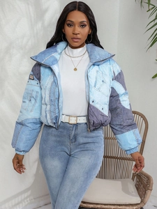 Detail view of contrast patchwork denim jacket with stand collar and front zipper