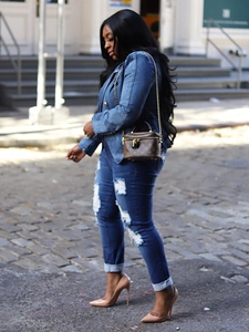 Slim fit double breasted denim blazer with gold buttons shown in a city street setting