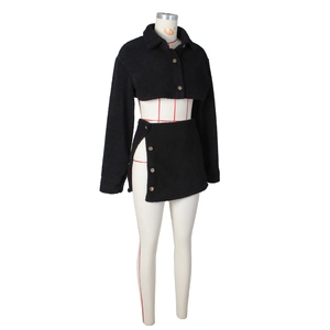 Detail of black fleece two-piece set with cropped jacket and side-split button mini skirt