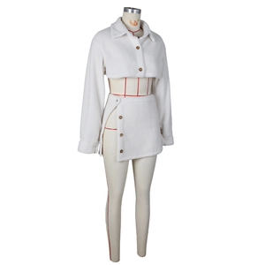 Detail of white faux shearling two-piece set featuring cropped jacket and buttoned skirt