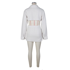 Detail view of white sherpa fleece two-piece set featuring a cropped top and mini skirt