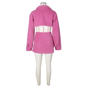 Detail view of hot pink faux shearling two-piece set featuring back of jacket and skirt