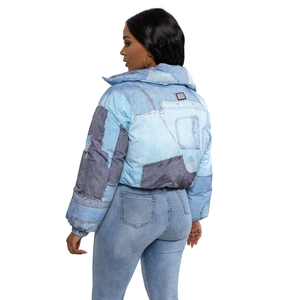 Close-up of short padded jacket featuring denim print patchwork and high collar design