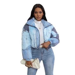 Detail of blue denim patchwork quilted jacket featuring stand collar and metal zipper