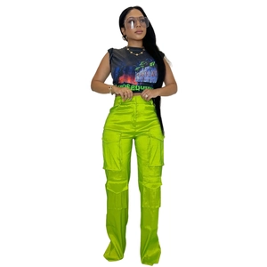 Détail d'un pantalon cargo en satin vert néon avec plusieurs poches et look urbain