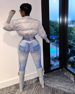 Close-up of metallic silver puffer jacket paired with denim-print leggings and boots
