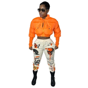 Detail of bright orange padded puffer jacket with stand collar and quilted texture