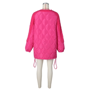 Detail view of pink quilted jacket with knitted splicing and drawstring at the hem