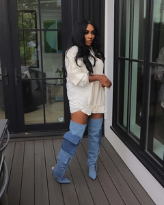 Detail of light blue denim over-the-knee boots with cargo pockets and pointed heels