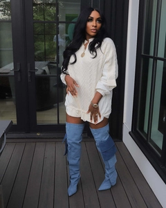 Oversize cable-knit sweater with drawstring hem and cargo-style denim over-the-knee boots