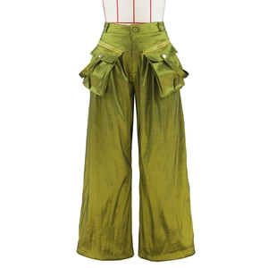 Detail of high-waist olive green cargo pants featuring 3D pockets and silky metallic texture