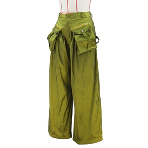 Detailed view of olive green wide-leg cargo pants with metallic zipper pockets